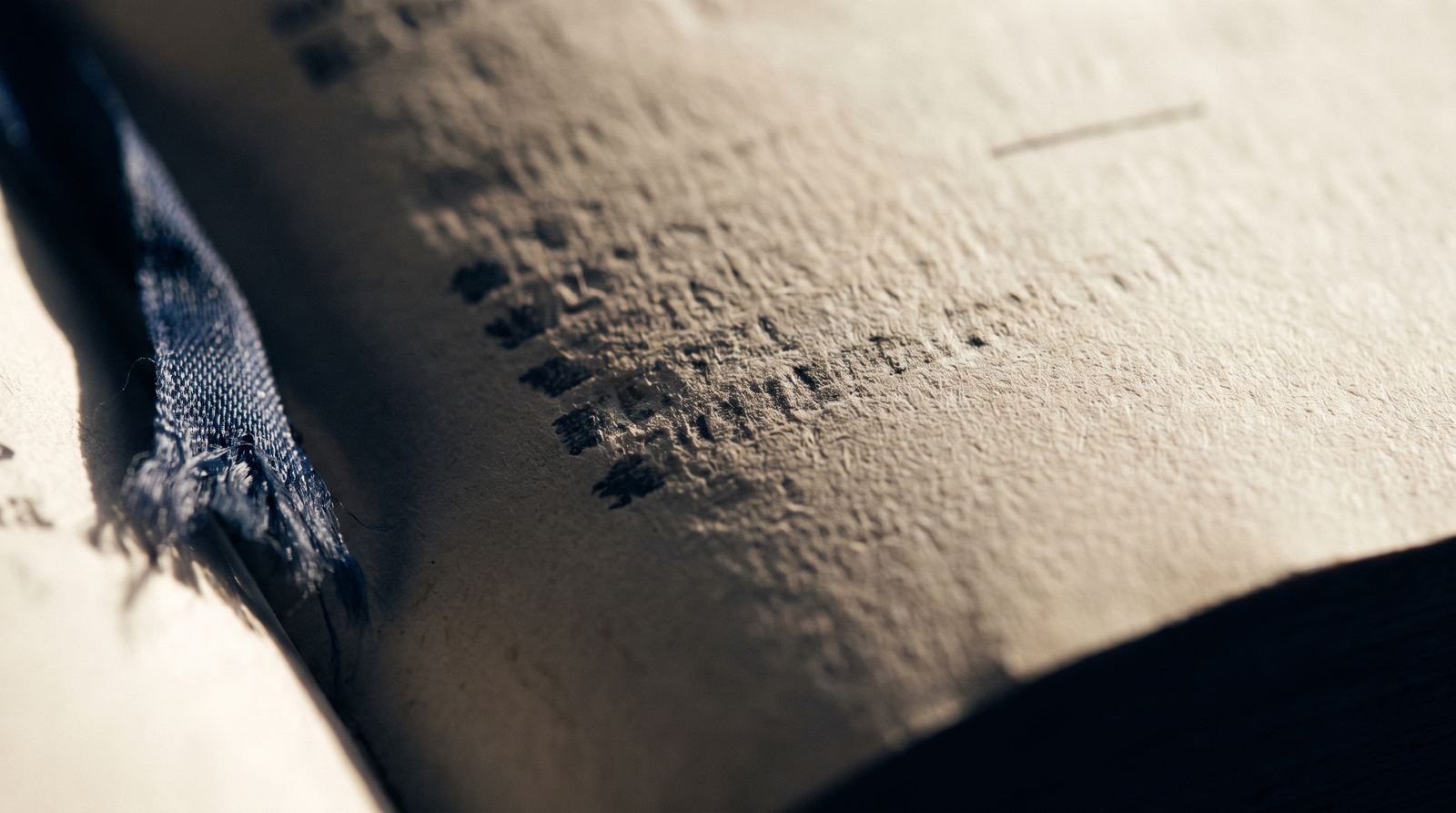 Raking light across the impressed type of a letterpress-printed statute page.